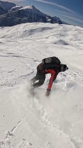 A thrilling vertical follow shot of a snowboarder kicking up snow. Perfect for Instagram Reels, TikTok, and high-energy mobile advertising.