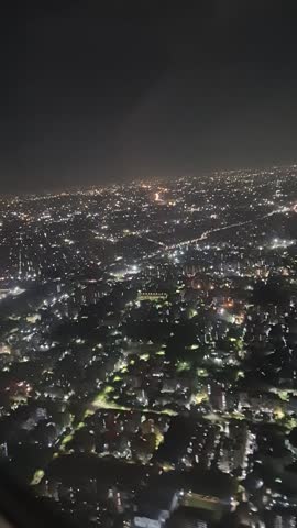 Description
An expansive aerial view of Delhi reveals a city of immense contrast and scale. From above, the older parts of the city are a chaotic mosaic of densely packed, multicolored buildings