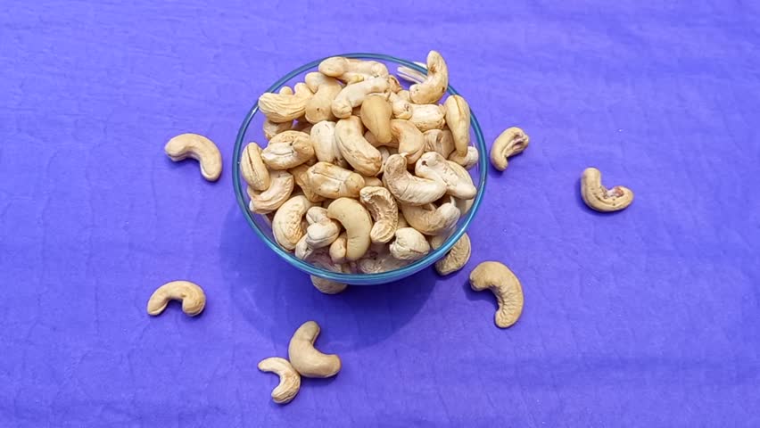 A bowl filled with cashew nuts. It showcases a nutritious snack option that can be enjoyed at any time, often incorporated into breakfast cereal or paired with dried fruit. 