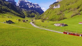 Experience a scenic train ride through the Swiss Alps. Enjoy breathtaking views of green meadows and snow-capped mountains. A perfect travel destination for nature lovers! - Powered by Shutterstock - Get 15% off with code: PIKWIZARD15