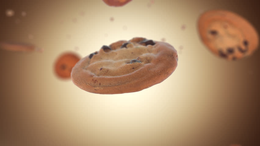Close up of chocolate chip cookie falling down in slow motion, light brown background. Suitable for commercial shots