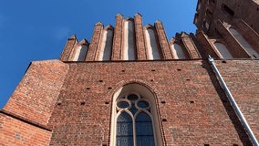Video of a gothic style brick wall featuring both a round decorative window and a tall arched window. The medieval architecture reflects cultural heritage and religious design. - Powered by Shutterstock - Get 15% off with code: PIKWIZARD15