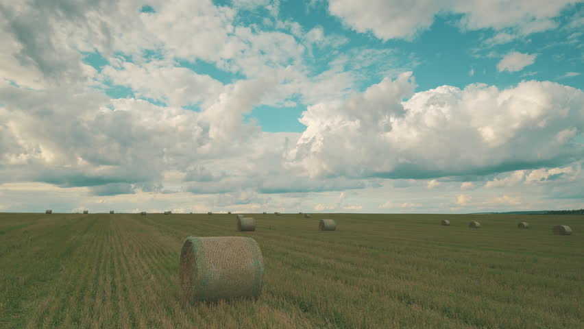Bales of Hay Sitting Under a Beautifully Dramatic Sky that Enhances the Landscape