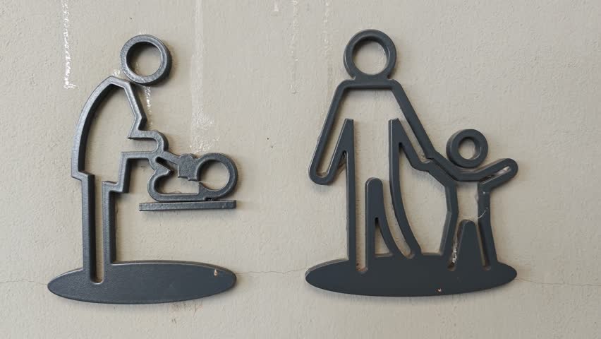 Public restroom symbol for children on a grey wall.