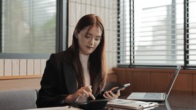 Professional businesswoman performing financial analysis, working efficiently at office desk with calculator and smartphone, reviewing business data with focused concentration - Powered by Shutterstock - Get 15% off with code: PIKWIZARD15