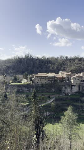 The charming medieval village of Rupit. The video shows its stone houses with wooden balconies and flowers, cobblestone streets, and its mountainous natural surroundings. Rupit, Spain