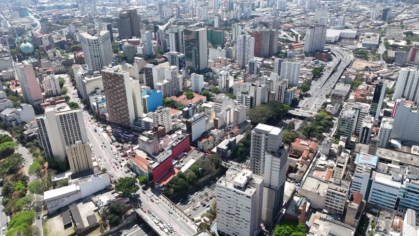 São Paulo, Brazil, showcasing skyscrapers, busy streets, and urban landscape under clear sky. Modern city life seen from above.