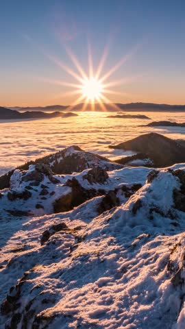Epic Sunrise Above Winter Mountains with Foggy Clouds Flow in Valley, Vertical Time-Lapse
