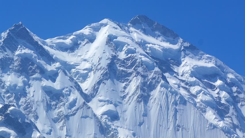 K2, also known as Mount Godwin-Austen, the world’s second-highest mountain, located in the Karakoram Range on the border of Pakistan and China.K2 120fps Slow Motion 4K Footage of rocky mountain peak.