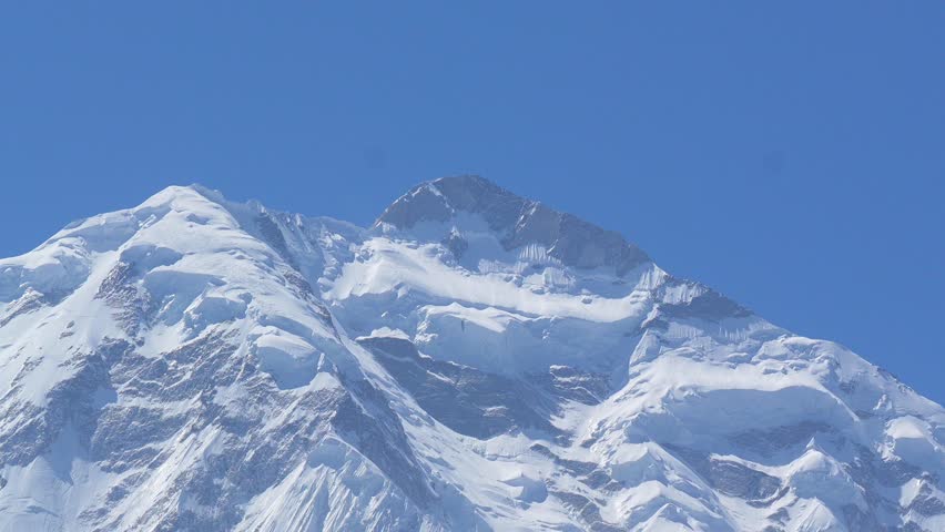 K2, also known as Mount Godwin-Austen, the world’s second-highest mountain, located in the Karakoram Range on the border of Pakistan and China.K2 120fps Slow Motion 4K Footage of rocky mountain peak.