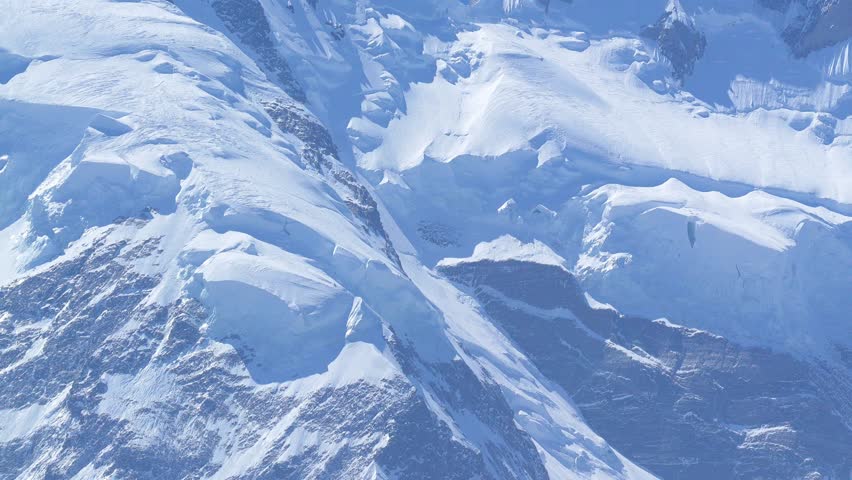 K2, also known as Mount Godwin-Austen, the world’s second-highest mountain, located in the Karakoram Range on the border of Pakistan and China.K2 120fps Slow Motion 4K Footage of rocky mountain peak.