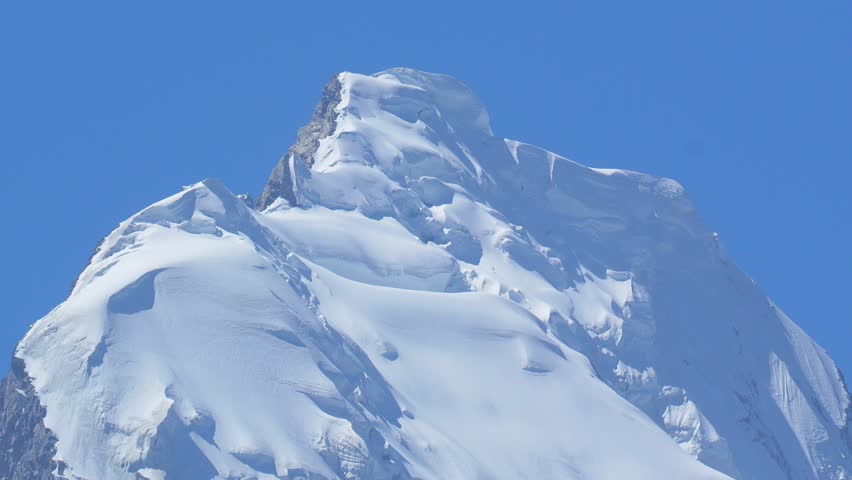 K2, also known as Mount Godwin-Austen, the world’s second-highest mountain, located in the Karakoram Range on the border of Pakistan and China.K2 120fps Slow Motion 4K Footage of rocky mountain peak.
