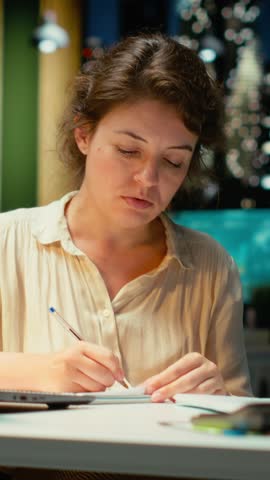 Vertical Video Corporate strategist ripping a paper after writing the wrong idea, restarting her work in rage and crumpling the page sheet, Discontent woman does a typo mistake while transcribing