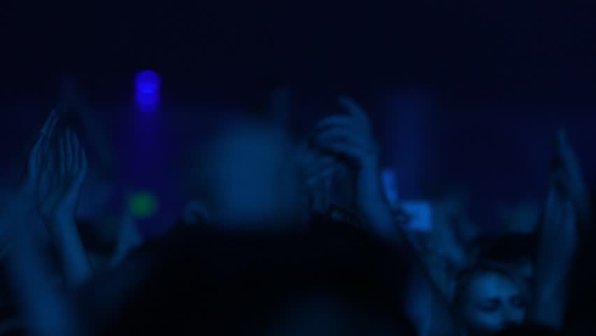 close up of hands dancing at concert, silhouettes