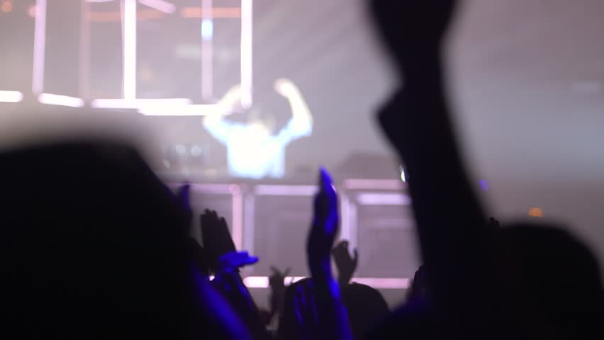 close up of hands dancing at concert, silhouettes
