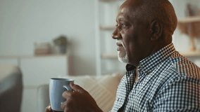 Senior man enjoying a quiet moment at home with a warm beverage - Powered by Shutterstock - Get 15% off with code: PIKWIZARD15