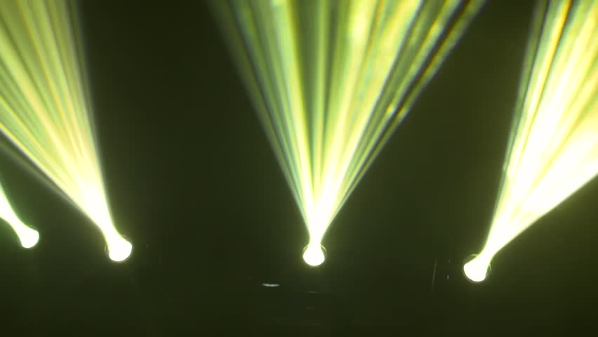 Silhouette of crowd dancing at concert with strobe lights
