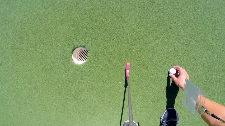 POV playing mini golf with putter