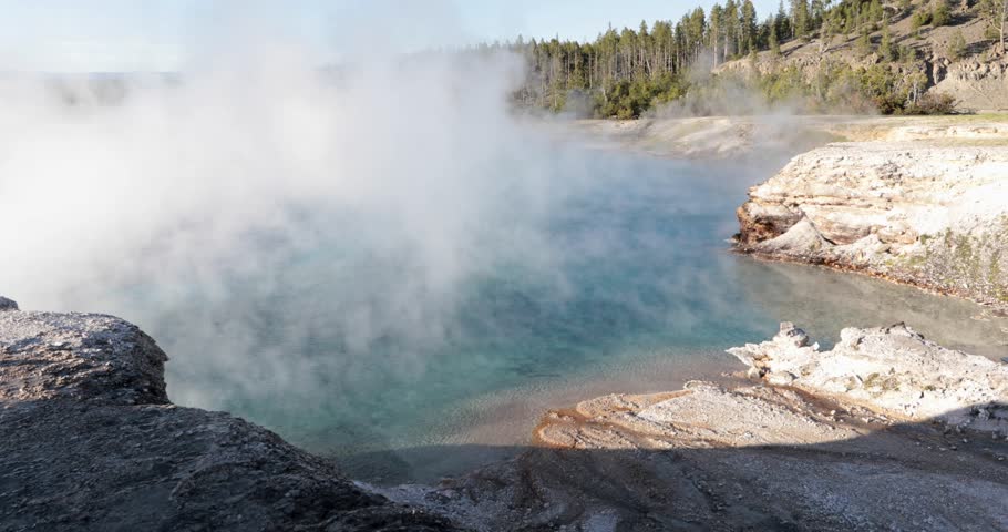A large body of water with steam rising from it. The steam is white and blue