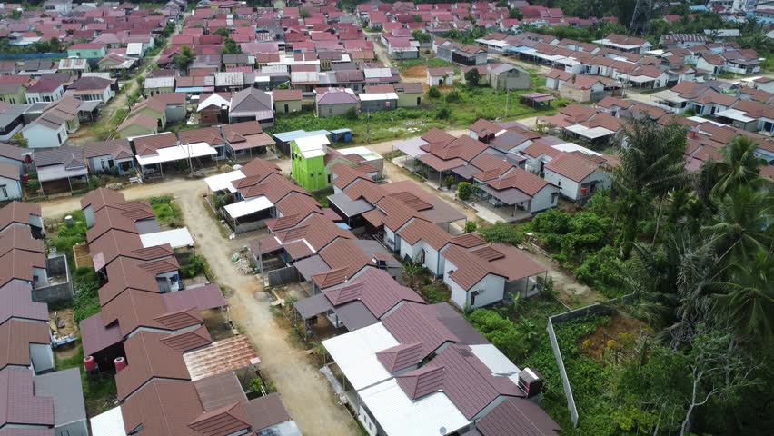 Aerial view of a residential area, some of which is still under construction, surrounded by agricultural areas