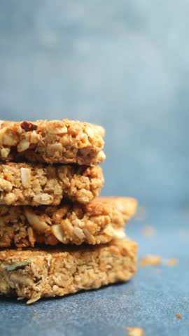 Healthy granola bars stacked on a blue background for snacking