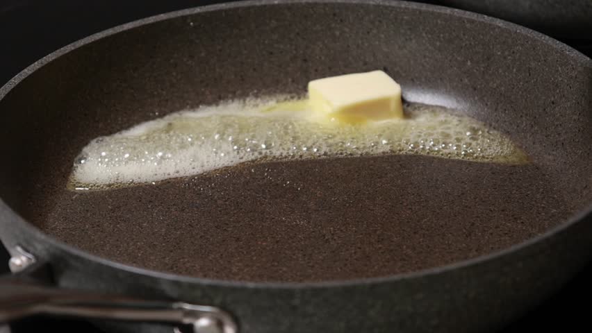 butter slowly melting in a hot pan
