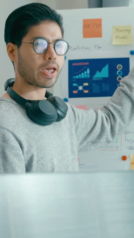 Vertical Screen : Group adult Asia male female software developers mentor leader manager talk strategy plan executive write prompt AI bot app nomad, video game, data center. Whiteboard slideshow code.