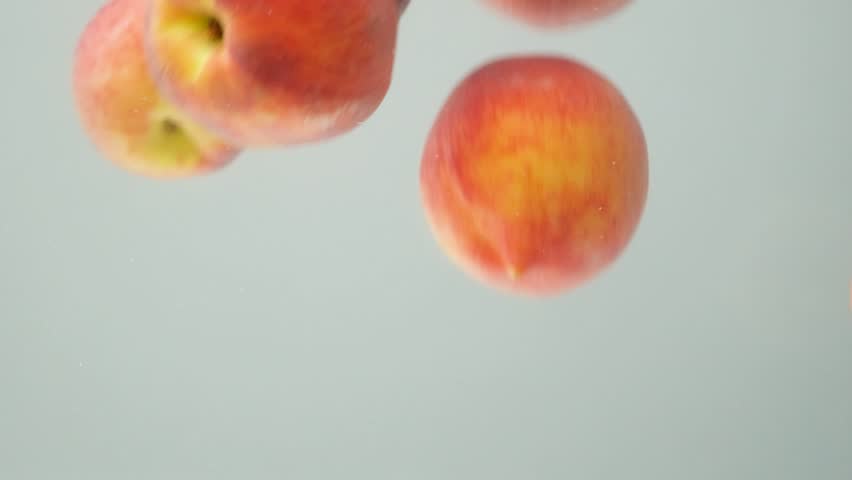 Dynamic Water Splash with Whole Peaches, Slow Motion Macro