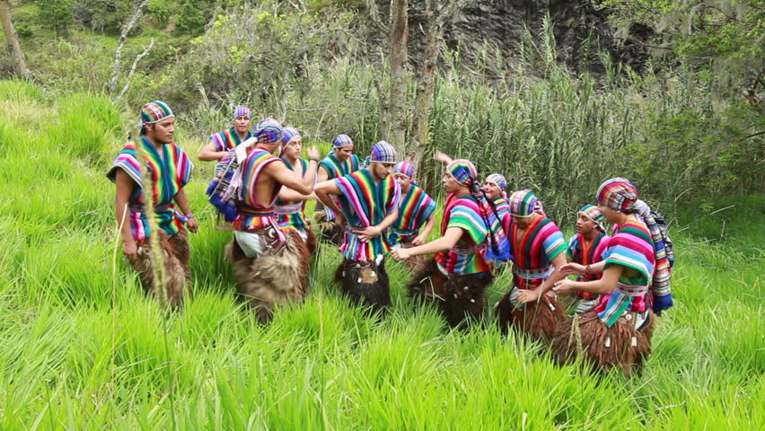 Twelve dancers performing a Ecuadorian dance, wearing traditional costumes,