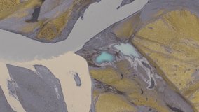 Aerial view of braided rivers carving through the landscape near Heinabergsjökull, presenting a palette of beige, grey and blue, Sveitarfélagið Hornafjörður, Iceland. - Powered by Shutterstock - Get 15% off with code: PIKWIZARD15