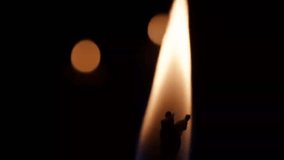 A macro close-up of a single candle flame flickering gently, set against a backdrop of soft bokeh lights. The dark, cozy atmosphere evokes calm, peace, and spiritual reflection—ideal for meditation, l - Powered by Shutterstock - Get 15% off with code: PIKWIZARD15