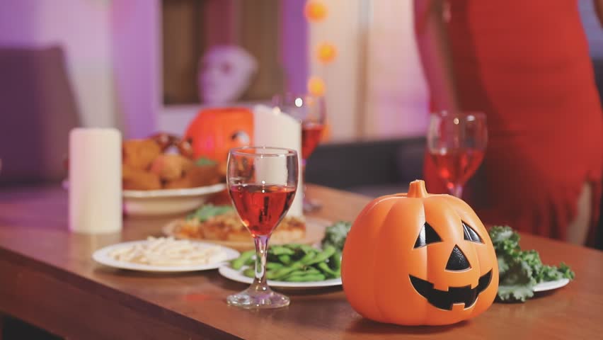 Joyful office Halloween party with coworkers in costumes, celebrating with drinks and laughter, fostering teamwork and festive spirit

