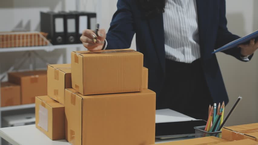 Starting small businesses SME owners man entrepreneurs working, box and check online orders to prepare to pack the boxes, sell to customers, sme business ideas online.