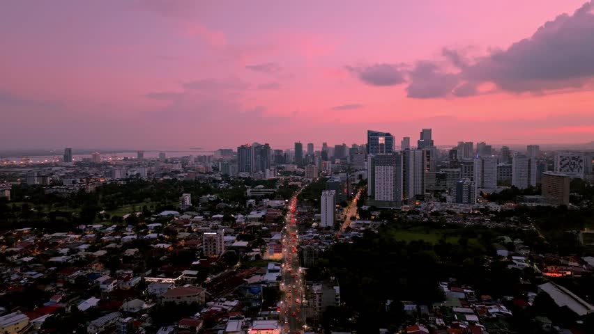 Aerial view of the cityscape during dusk, showing the buildings and skyline under a pink and purple sky, Cebu City, Central Visayas, Philippines.