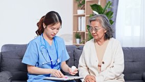 Asian Nurse providing healthcare consultation and medication guidance to elderly woman in living room with clipboard and stethoscope, ensuring attentive home care support and health discussion - Powered by Shutterstock - Get 15% off with code: PIKWIZARD15