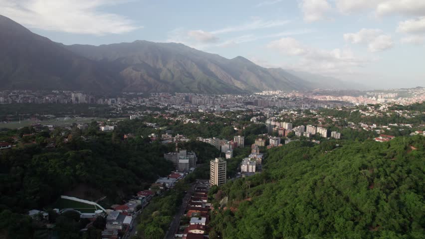 Drone view of city near mountains and coffee farm with calm vibe