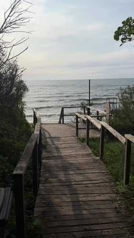 Wooden path to beach and sea waves