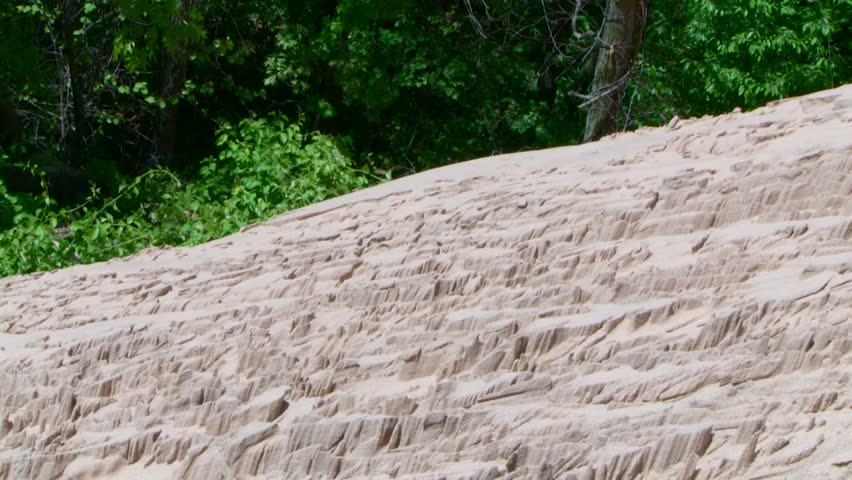 Detailed close up shot of jagged sand textures on dune slope, tilt down movement, Indiana Dunes, Lake Michigan