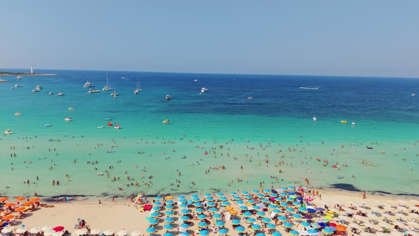 Crowded beach in San Vito Lo Capo, Sicily with clear blue sea
