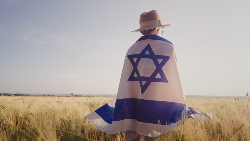 Jewish Woman Stands Alone In Open Field, Holding Israeli National Flag. Heritage