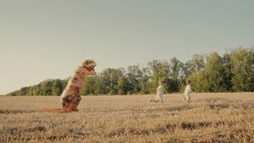 Little kids boys chased by person in inflatable dinosaur T-Rex costume in field - Powered by Shutterstock - Get 15% off with code: PIKWIZARD15
