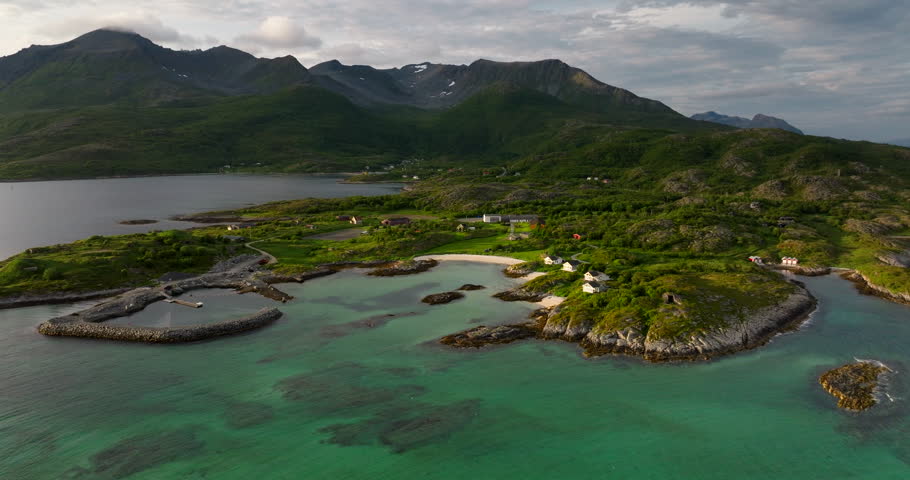 Senja Island. Aerial Descending view over turquoise coves and cabins