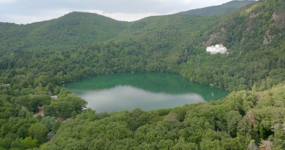Aerial view of abbey of San Michele surrounded by trees. It is a Benedictine Abbey located at the foot of Monte Vulture, on the flank of the Monticchio Lake Piccolo, in Basilicata, Italy.