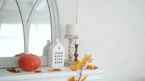 Autumn fireplace decor with pumpkin candle house and fall leaves on white mantel - Powered by Shutterstock - Get 15% off with code: PIKWIZARD15