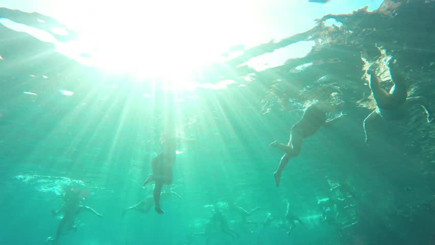 Vacationers female tourists swim in the sea at great depth in the rays of the sun