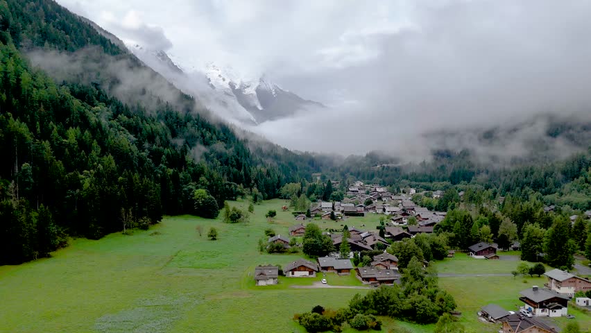 High resolution 4k drone aerial video of the beautiful town of Argentiere France an integral part of the famous TMB- Tour du Mont Blanc trail during a foggy peaceful morning in the month of September
