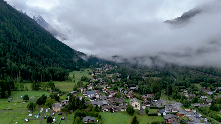 High resolution 4k drone aerial video of the beautiful town of Argentiere France an integral part of the famous TMB- Tour du Mont Blanc trail during a foggy peaceful morning in the month of September