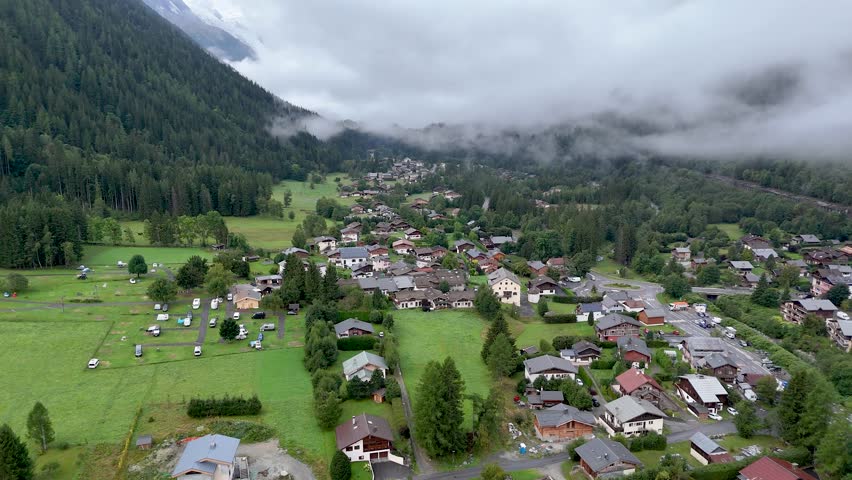 High resolution 4k drone aerial video of the beautiful town of Argentiere France an integral part of the famous TMB- Tour du Mont Blanc trail during a foggy peaceful morning in the month of September