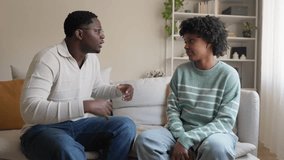 Angry african american couple arguing and fighting on the couch in slow motion. Upset young black couple is emotionally gesturing and talking, sitting on a sofa at home.
 - Powered by Shutterstock - Get 15% off with code: PIKWIZARD15