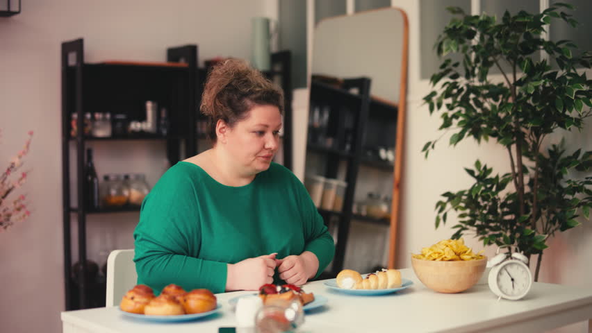 Large woman eating sweet desserts, sugar addiction and compulsive overeating